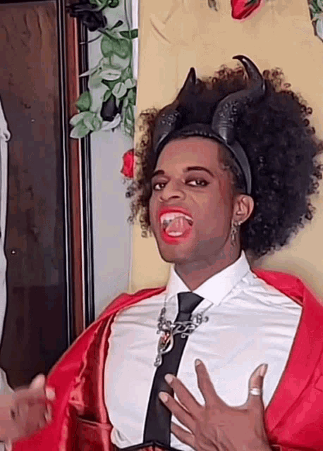 a man in a devil costume with horns and red lipstick