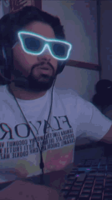 a man wearing headphones and sunglasses is wearing a t-shirt that says " aovah "