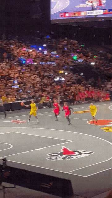 a basketball game is being played in a stadium with a chicago bulls logo on the floor