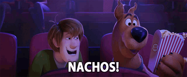 scooby doo and shaggy are watching a movie and scooby is holding a bag of nachos