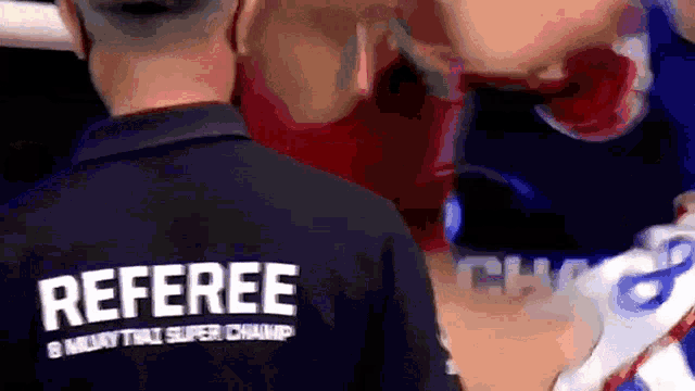 a referee wearing a shirt that says 8 muaythai super champ