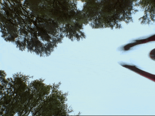 a person in a red superhero suit is flying through the air