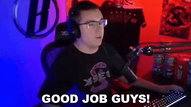 a man wearing headphones and glasses is sitting in front of a computer and saying `` good job guys ! ''