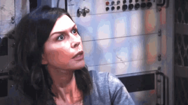 a woman with a surprised look on her face is looking at something