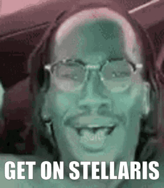 a man wearing glasses is smiling with the words get on stellaris written below him