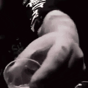 a close up of a person holding a glass in their hand in a black and white photo .
