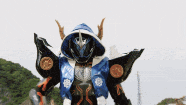 a blue and black robot with a hood on