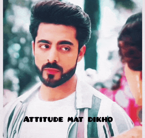 a man with a beard looks at a woman with the words attitude mat dikho below him