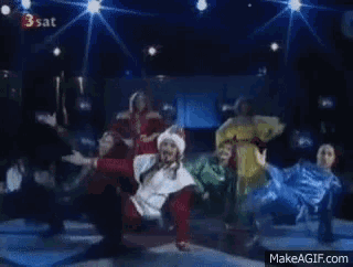 a group of people are dancing on a stage with a makeagif.com link in the corner