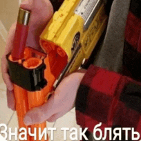 a person in a plaid shirt is holding a yellow and orange nerf gun in their hands .