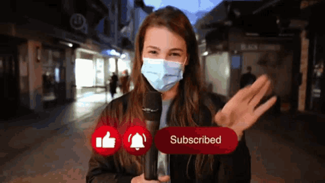 a woman wearing a face mask holds a microphone with a subscribed button in front of her