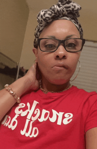 a woman wearing glasses and a red shirt that says " choose " on it