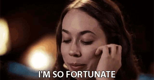 a woman is talking on a cell phone while saying i 'm so fortunate .