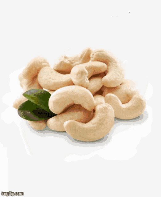 a pile of green raisins with a white background
