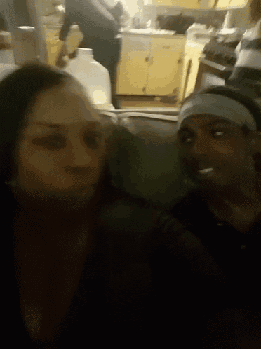 a man and a woman are posing for a picture