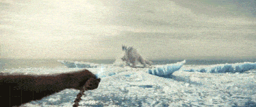 a person is holding a chain in front of a large iceberg
