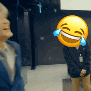 a man with a smiley face on his face laughs
