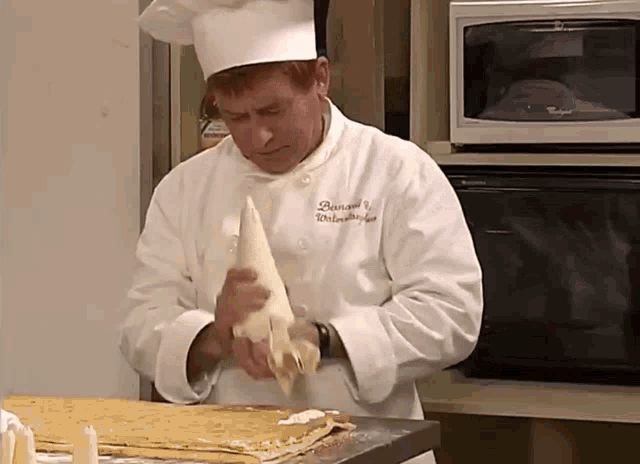 a man in a chef 's uniform has the name bernard on his jacket