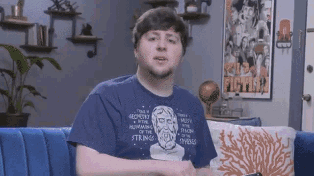 a man wearing a blue shirt that says strings