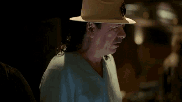 a man wearing a white hat is looking down