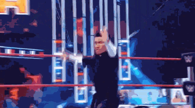 a blurry picture of a man in a wrestling ring with a w logo