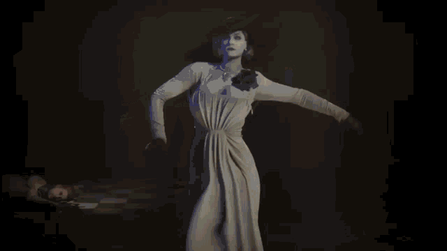 a woman in a white dress is dancing in a dark room .
