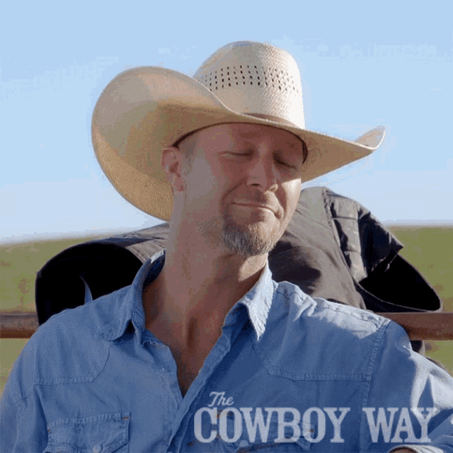 a man wearing a cowboy hat and a shirt that says the cowboy way on it