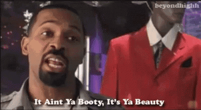 a man in a red suit says it aint ya booty it 's ya beauty .