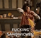 a woman is making a sandwich in a kitchen while holding a broom .