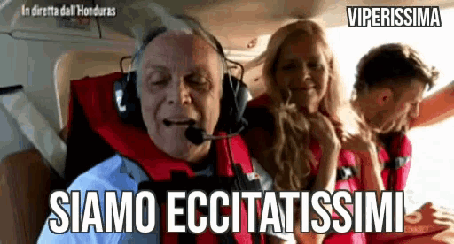 a man wearing headphones says " siamo eccitatissimi " while sitting on a plane