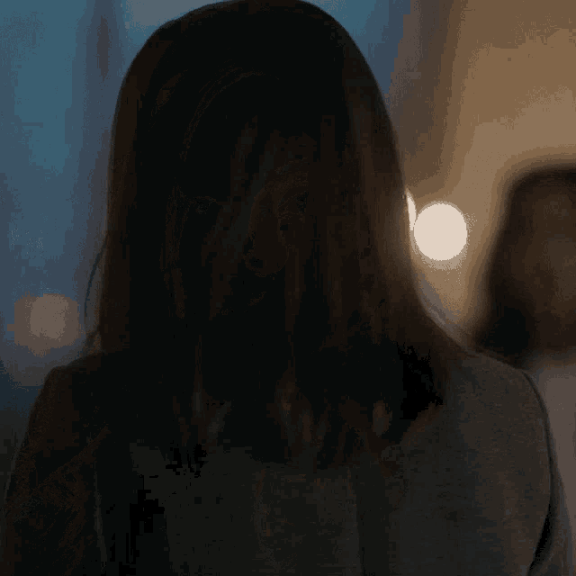 a woman 's back is shown with a blurry background