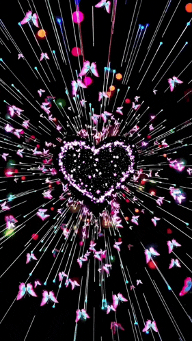 a heart shaped firework display with butterflies flying around it