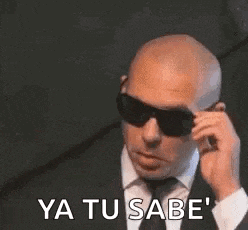 a man in a suit and tie is talking on a cell phone .
