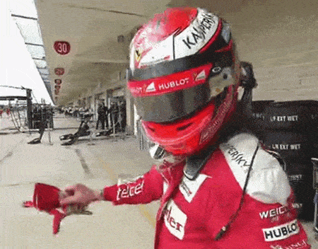 a man wearing a red helmet that says hublot on it
