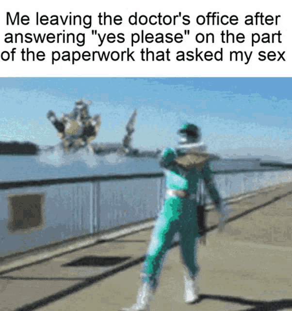 a blurred image of a green power ranger standing in front of a body of water