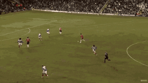 a group of soccer players are playing on a field with a casino ad in the stands