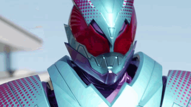 a close up of a purple and blue robot with red eyes and a helmet .