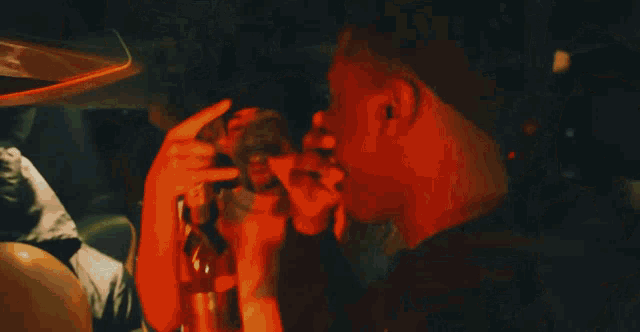 a man in an orange hoodie holds a gun