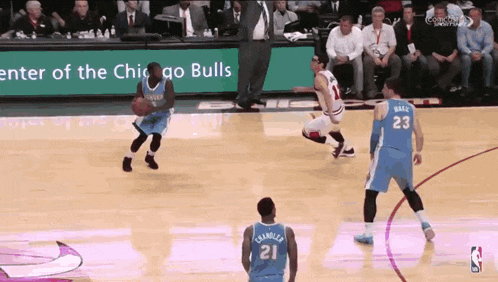 a basketball game is being played in front of a sign that says " enter of the chicago bulls "
