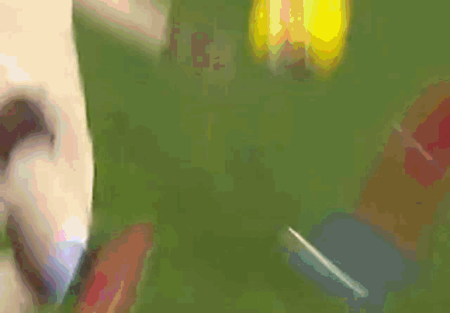 a soccer player is kicking a ball in front of a large ark sign