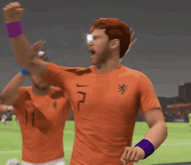 a man in an orange shirt with the number 2 on it