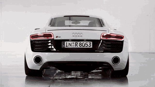 a white audi sports car has a license plate that says inr 8053