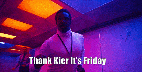 a man in a white turtleneck says thank kier it 's friday while dancing