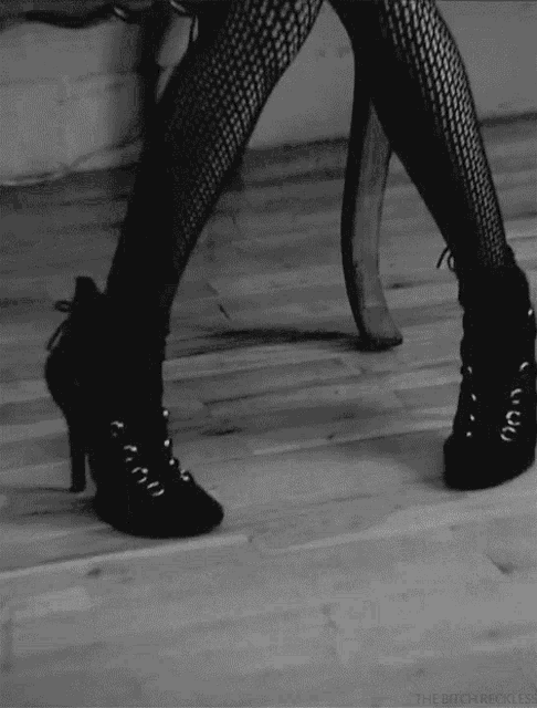 a black and white photo of a woman 's legs with the words the bitch reckless on the bottom