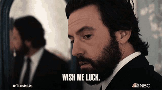 a man with a beard says " wish me luck "