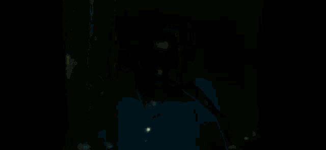 a blurry picture of a man in a blue shirt