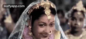 a close up of a woman in a wedding dress smiling .