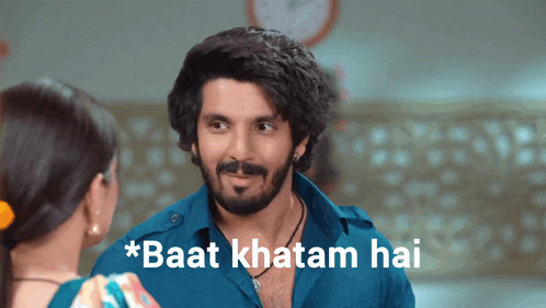 a man with a beard is looking at a woman with the words * baat khatam hai * below him
