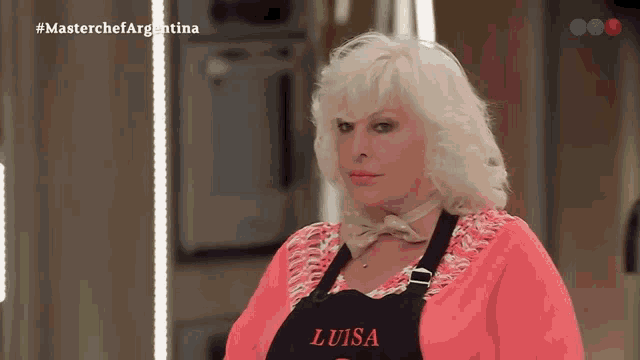 a woman wearing a black apron that says luisa