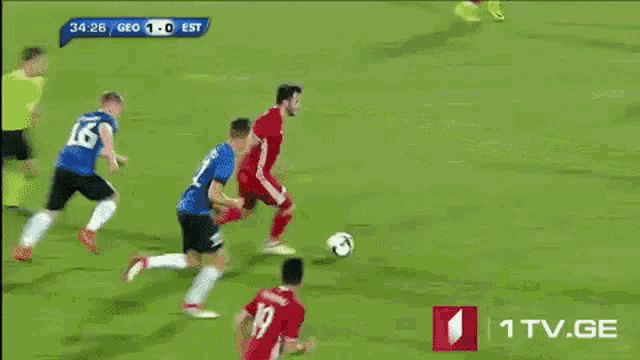 a soccer game is being played in a stadium with advertisements for 1tv.ge
